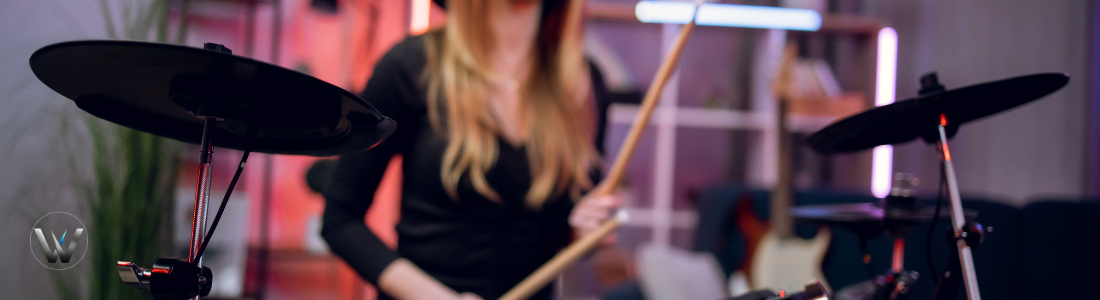 Person playing drums with a blurred background