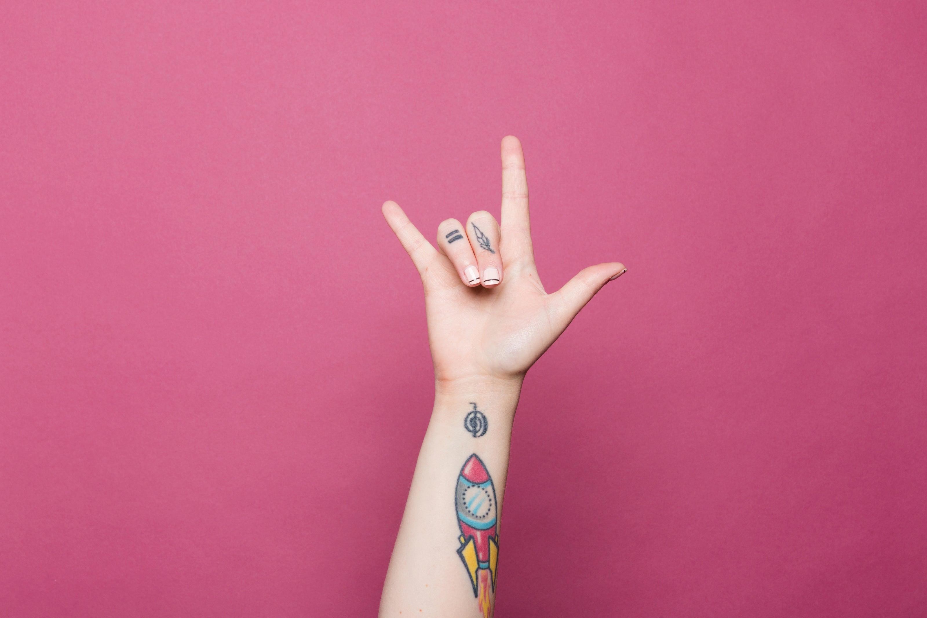 a-tattooed-hand-doing-the-sign-for-i-love-you